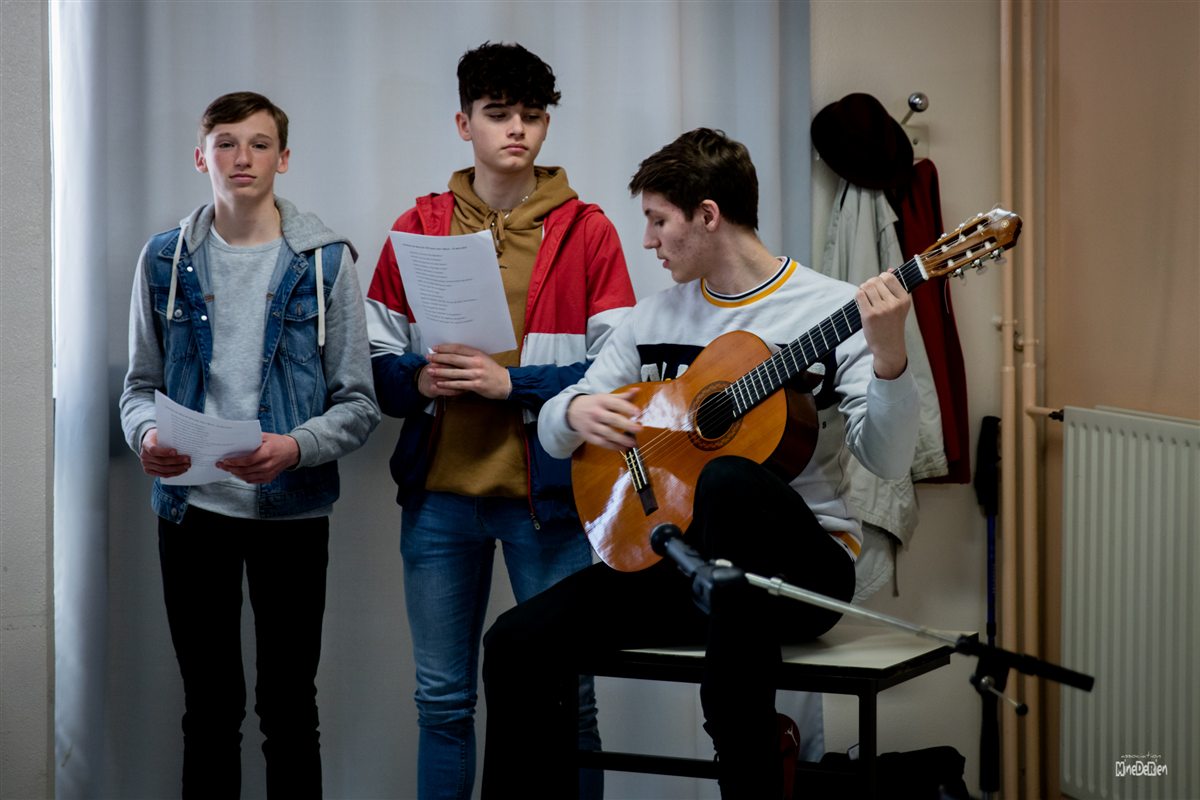 Des élèves chantent et jouent de la guitare ensemble au lycée